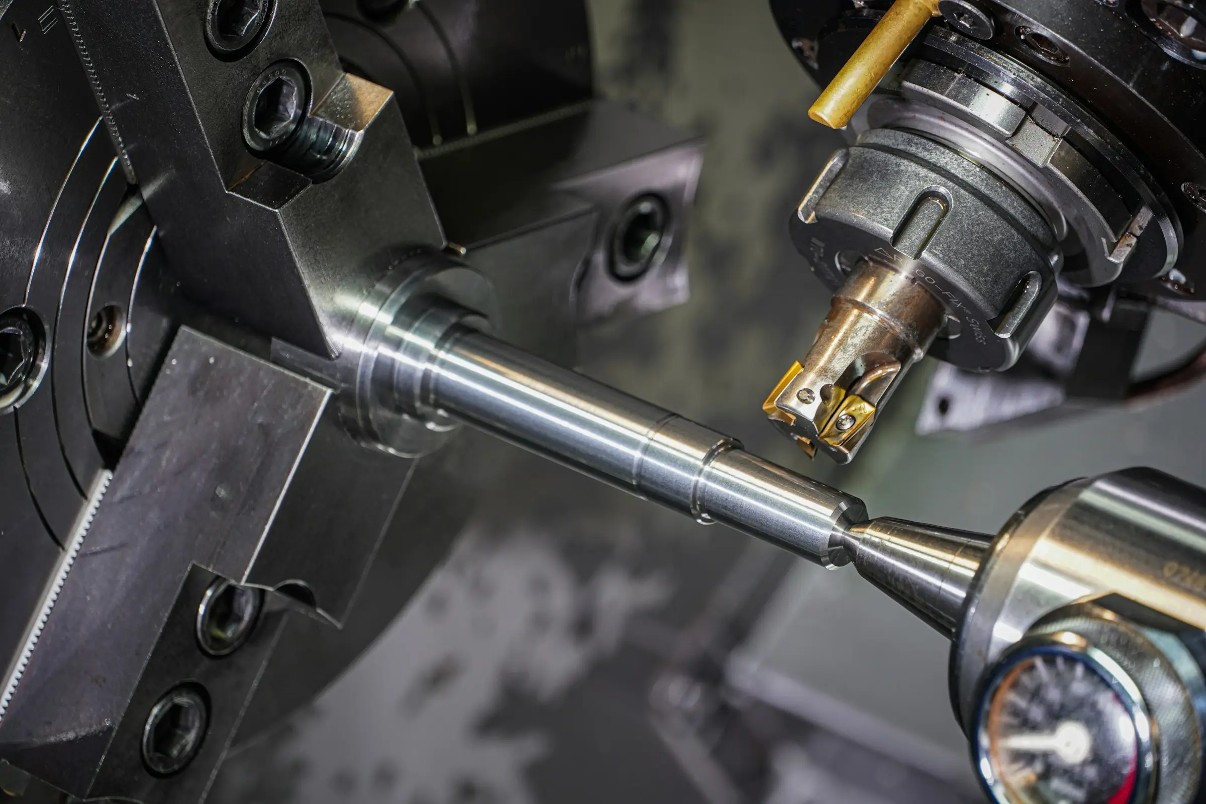 A metal component being machined to tolerance on a lathe.